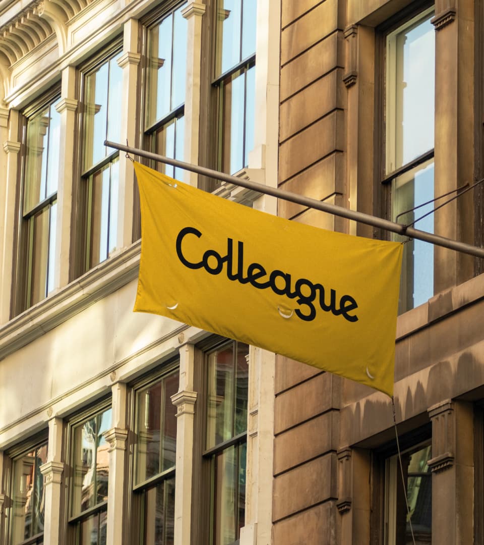 Yellow Colleague flag mounted outside a city building