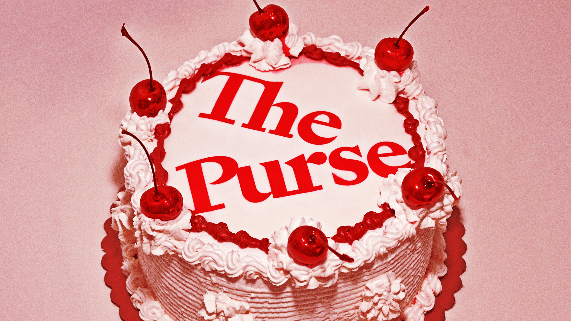 Celebration cake decorated with The Purse logo in red lettering