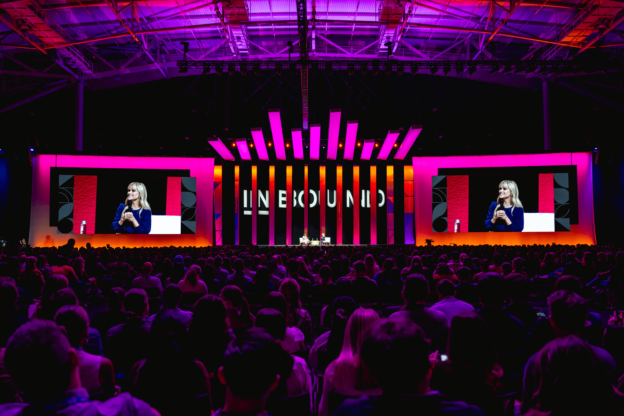 HubSpot INBOUND conference main stage illuminated in magenta and orange