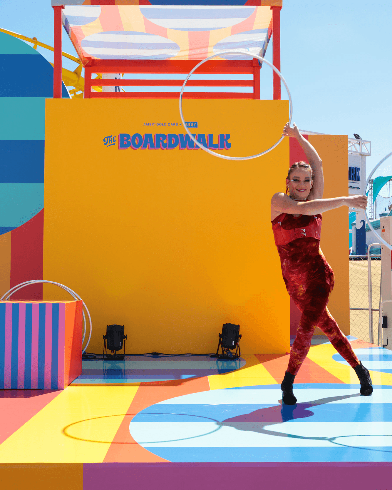 Performer with a hoop at the colorful Resy and American Express Boardwalk event