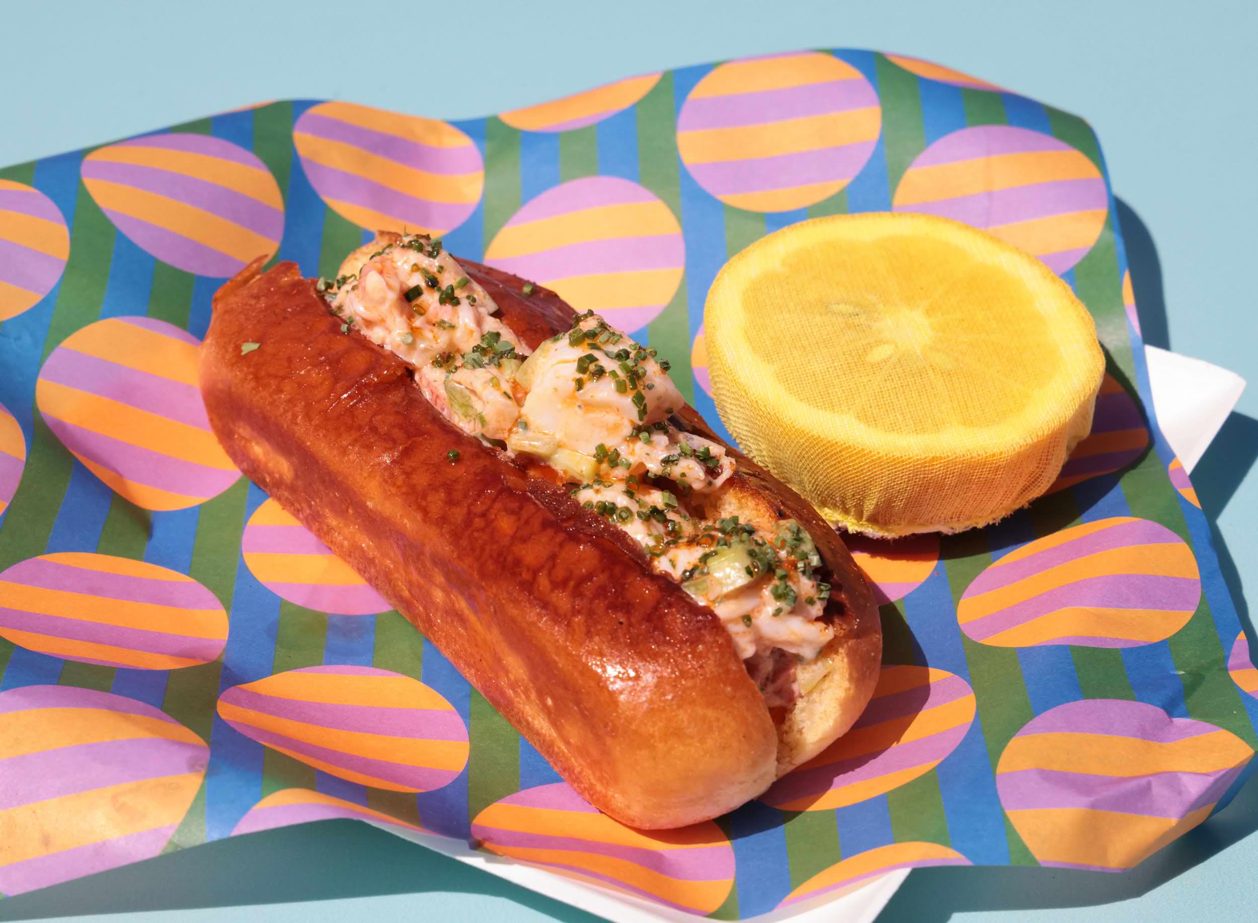Lobster roll served on a colorful patterned tray at The Boardwalk